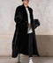 Stylish woman in a long black mink coat, showcasing luxury and versatility for both formal and sporty looks.