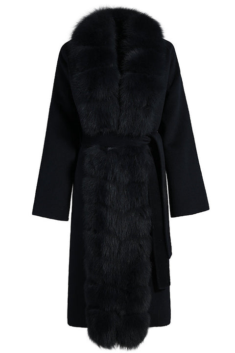 Black cashmere coat with voluminous fox fur collar, combining luxury materials and timeless design.