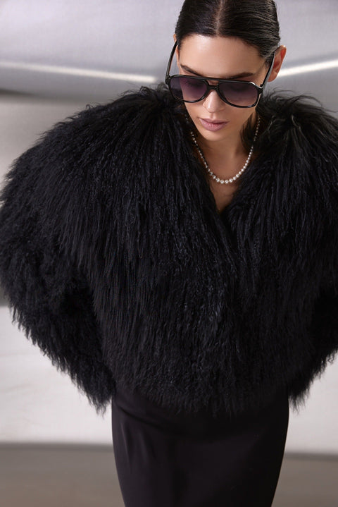 Stylish woman wears the soft, thick Mongolian fur coat, showcasing its seamless design and practical features perfect for winter elegance.