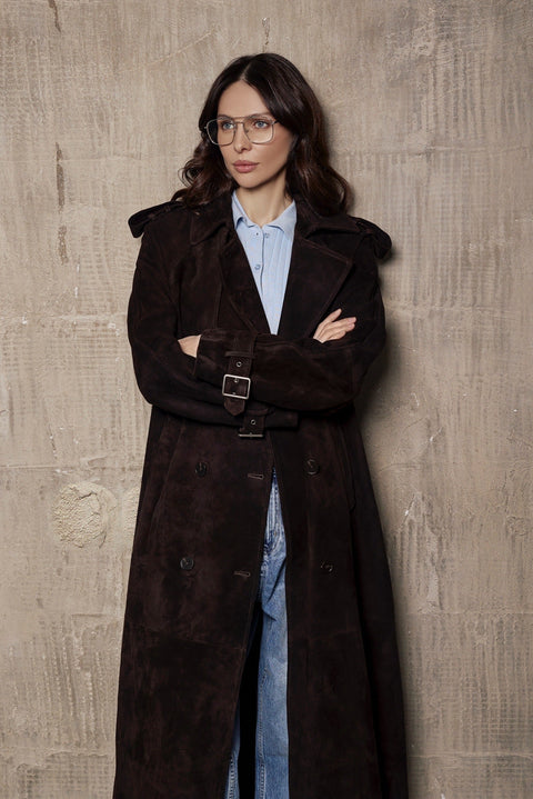 A woman models a modern suede trench coat with structured shoulders and a fitted waist, made from luxurious high-grade suede.